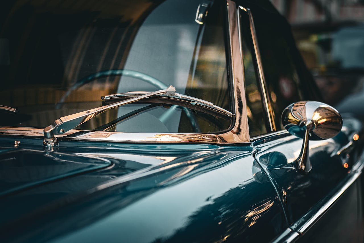 Artistic close-up shot of a vintage classic car showcasing its chrome details and reflections.